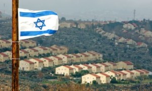 Israeli flag flutters over view of Jewish settlement of Ofra