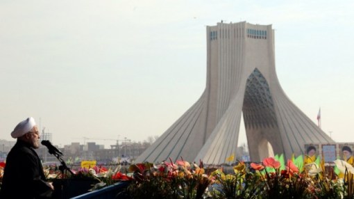 Iranian President Hassan Rouhani waves as he delivers a speech during a rally in Tehran's Azadi Square (Freedom Square) to mark the 35th anniversary of the Islamic Revolution on February 11, 2014. (photo credit: AFP/ATTA KENARE)
