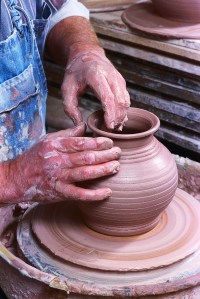 Potter Crafting Pot on Potter's Wheel